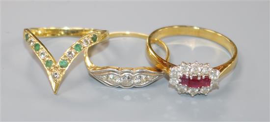An 18ct gold, ruby and diamond cluster ring and two other 18ct gold rings,